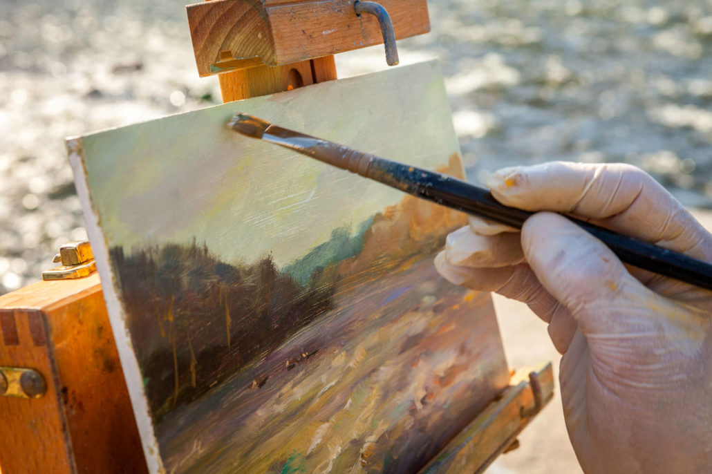 Closeup of a Fine Artist Painting A Landscape on Easel
